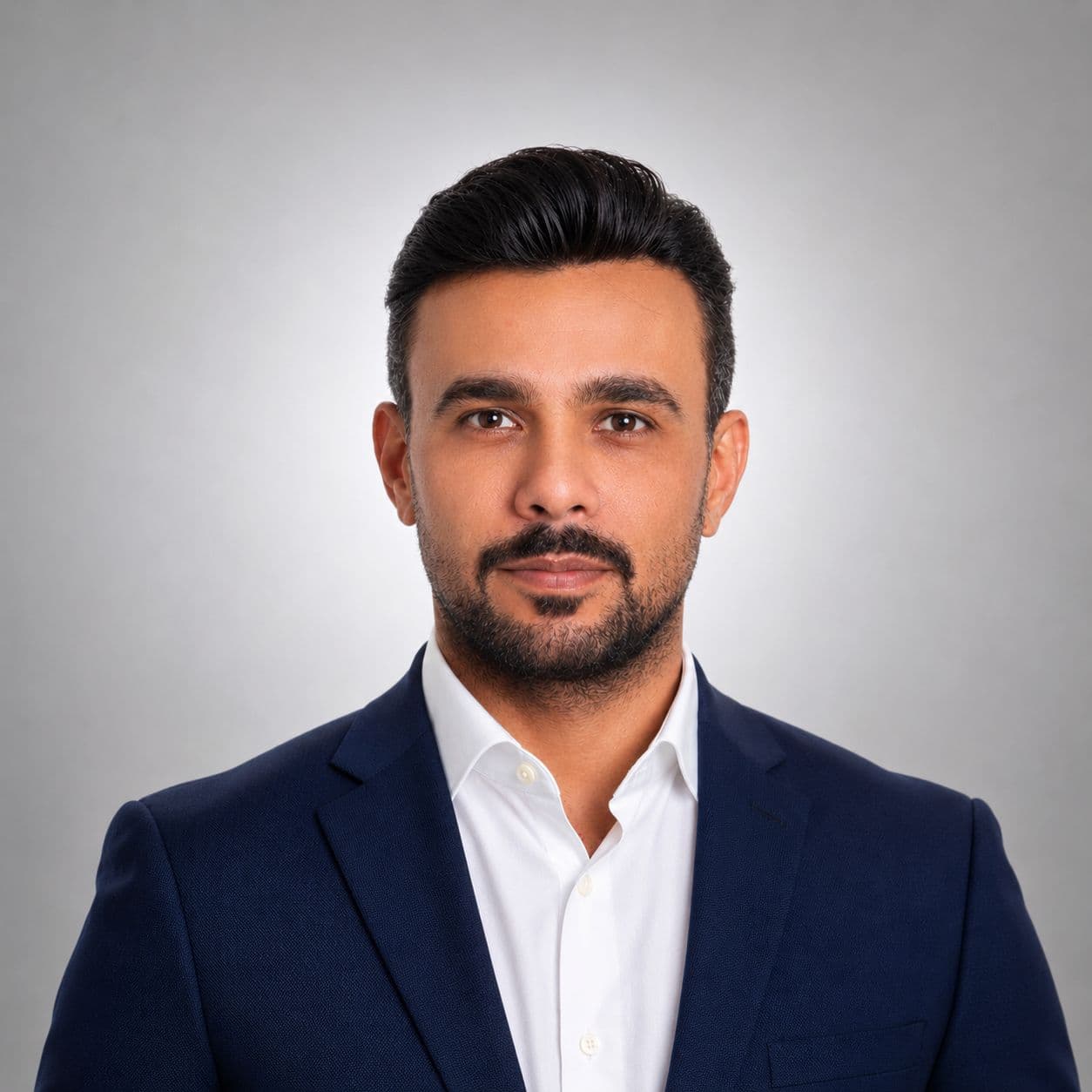 Capt. Bader Shaheen, Founder & Executive Chairman and Technical Lead of Peregrine AI Capital — professional studio portrait in navy blazer